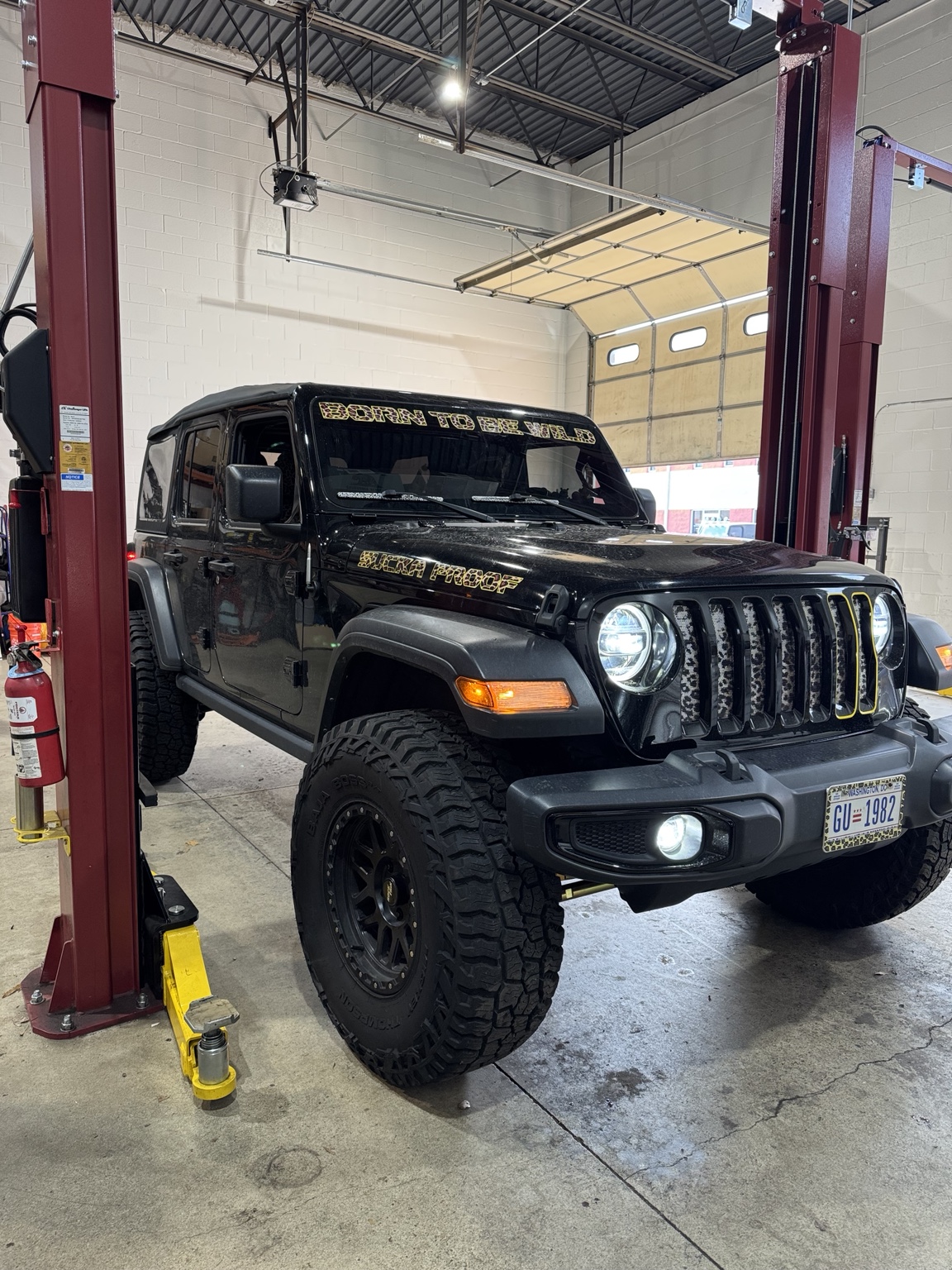 Black Jeep Wrangler positioned on a lift at Bull Run 4x4 for steering and death wobble diagnosis